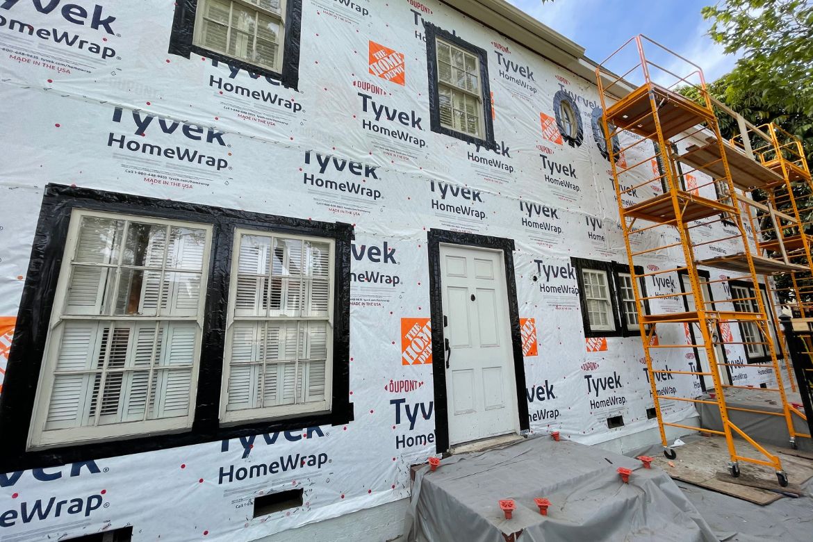 Exterior waterproofing and Tyvek house wrap installation on residential property