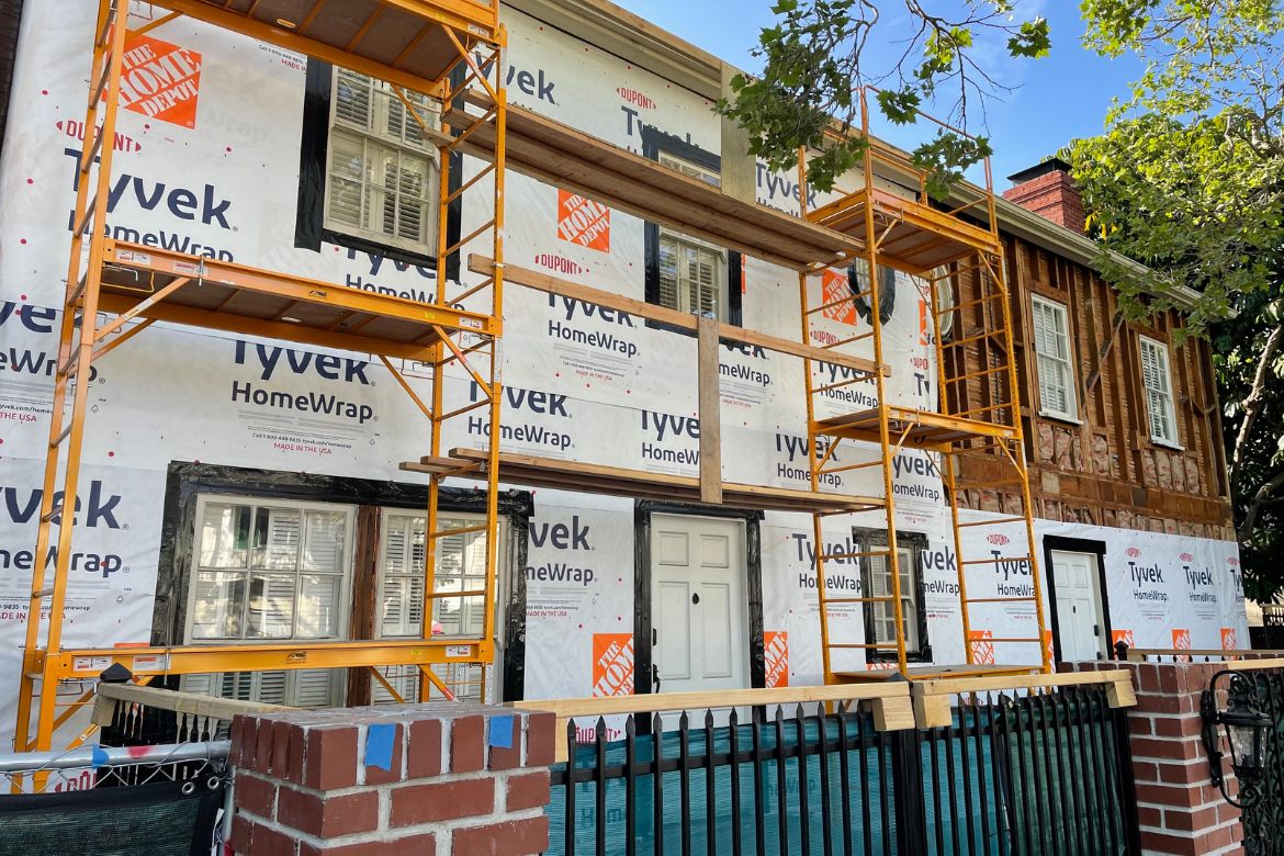 Residential home exterior wrapped with Tyvek during weatherproofing phase of remodel