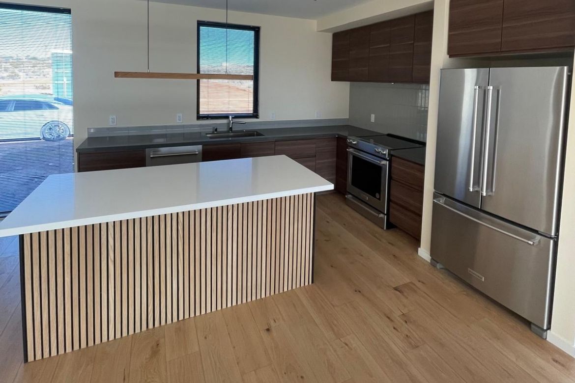 Custom modern kitchen with wood cabinetry and island in a Joshua Tree residence