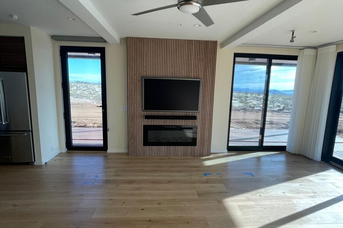 Minimalist living room with built-in fireplace and desert views in a Joshua Tree home