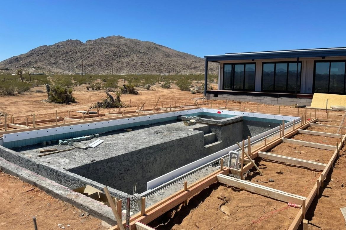 In-ground concrete pool construction in progress at a Joshua Tree custom home site