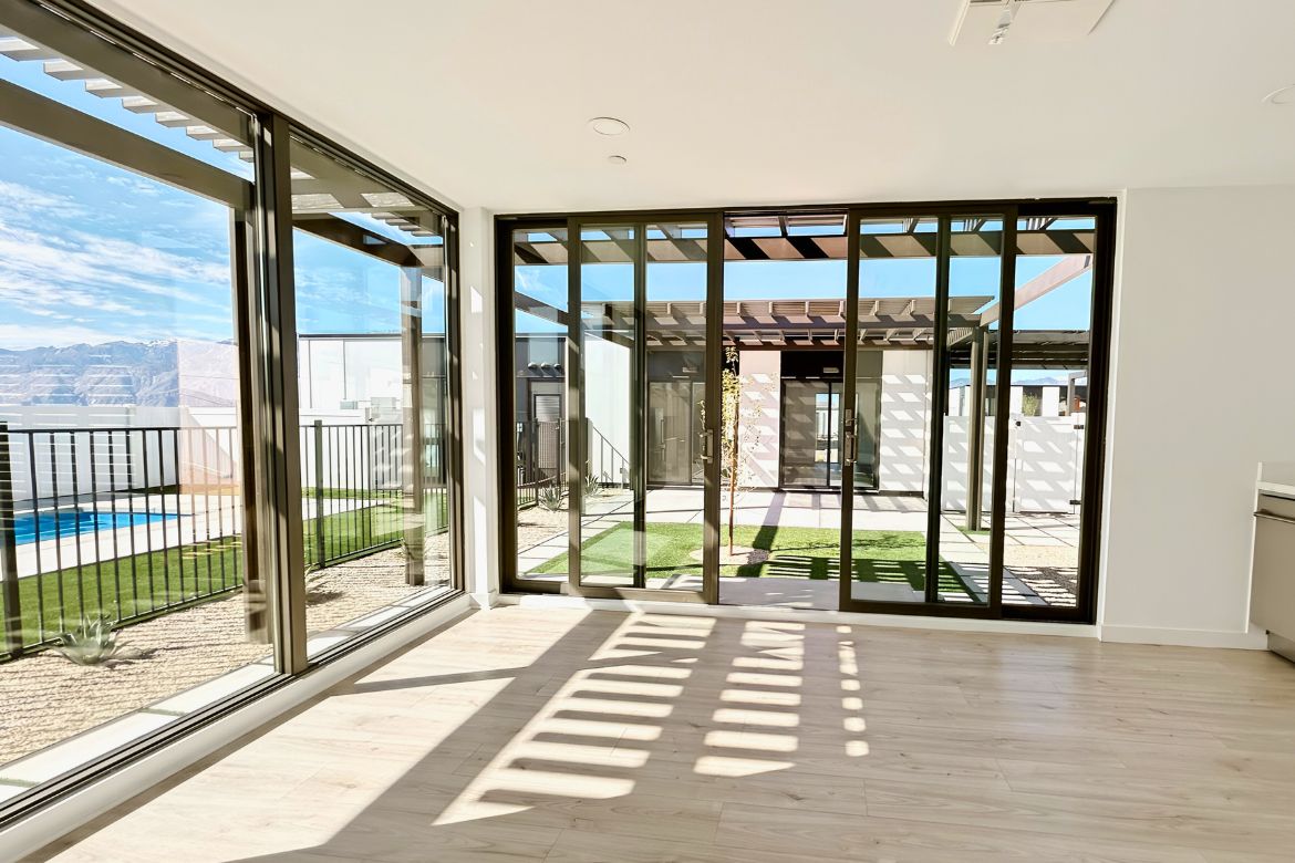 ADU interior with floor-to-ceiling sliding glass doors connecting living space to private courtyard