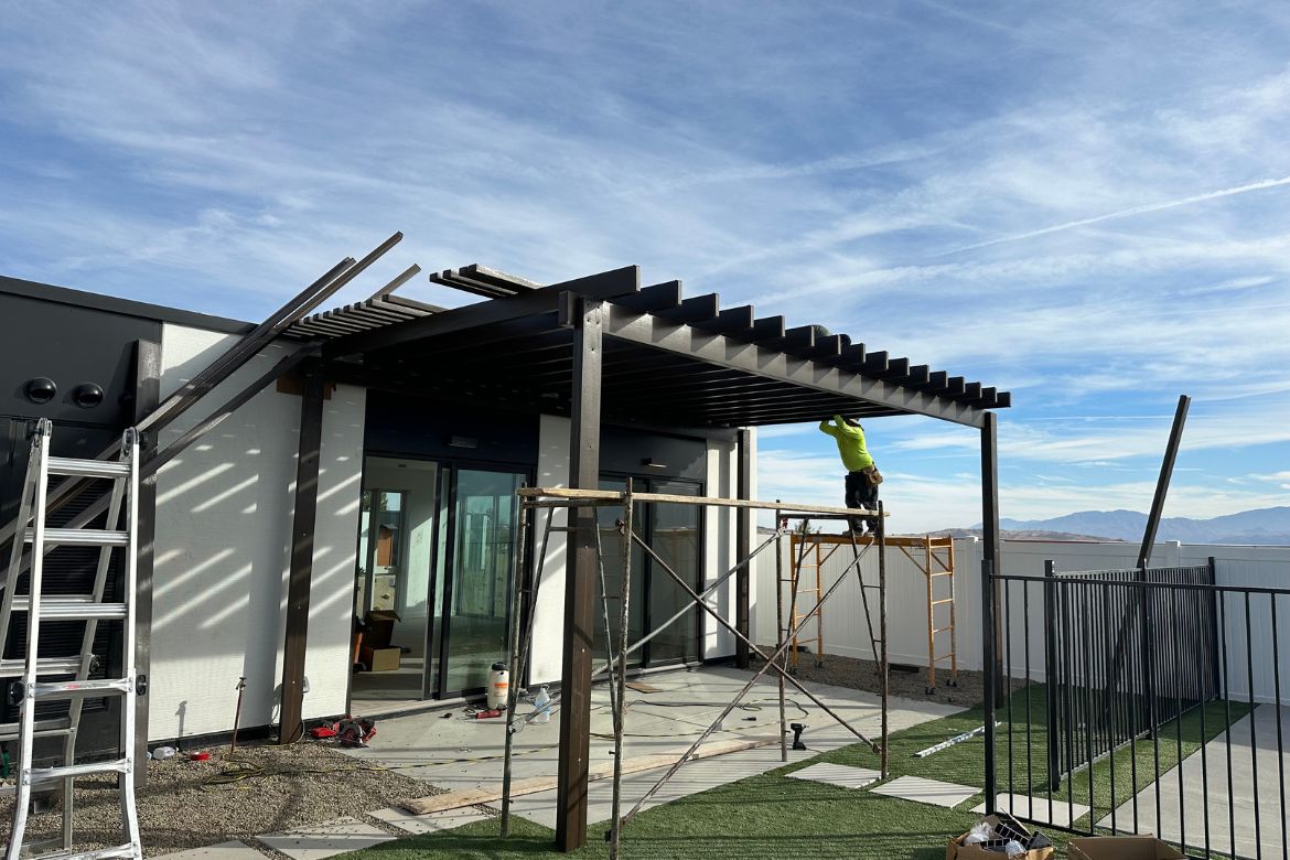 Custom pergola installation in progress for residential backyard during ADU construction project